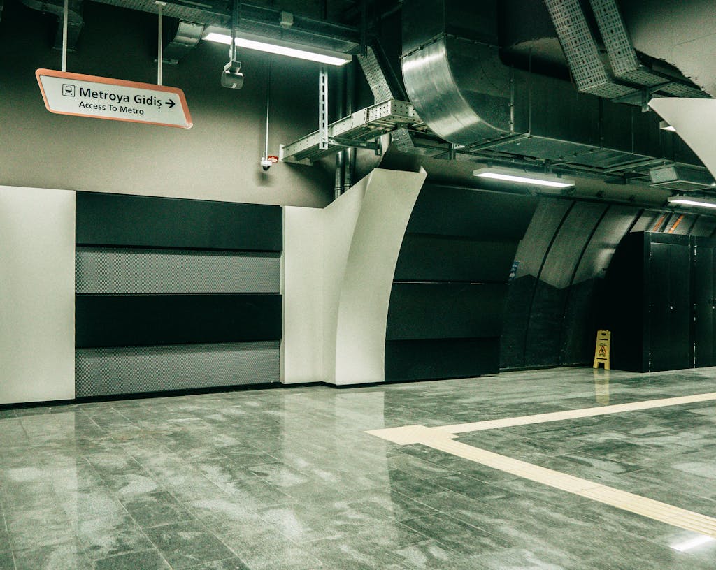 A minimalist interior of an Istanbul subway station with signage and modern design.